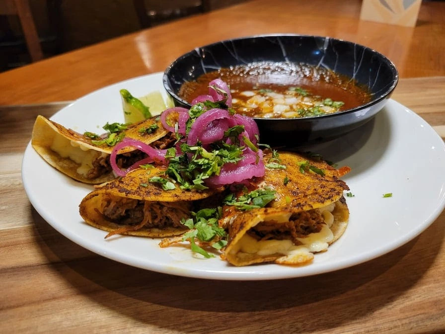Crispy halal beef pockets with pickled onion, herbs and a rich dipping sauce at DJ Donair & Poutine in Ellerslie, Edmonton