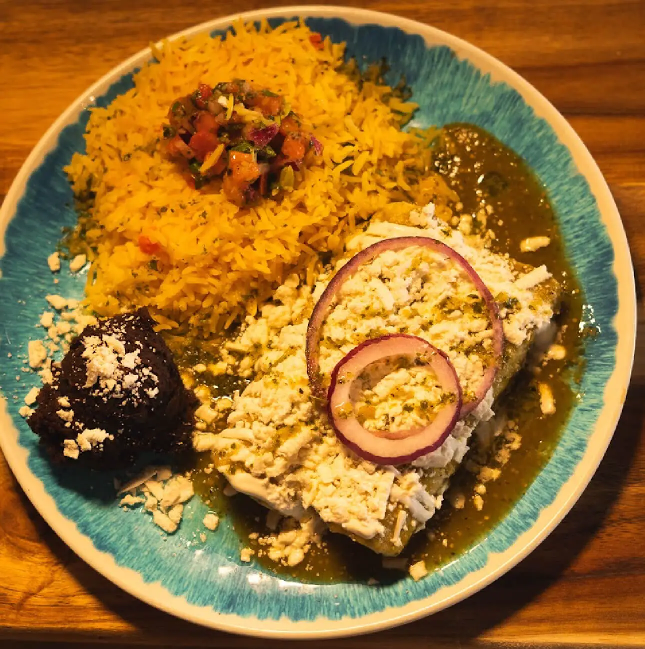 Seasoned rice platter with saucy halal beef, crumbled cheese and pickled onion at DJ Donair & Poutine in Ellerslie, Edmonton